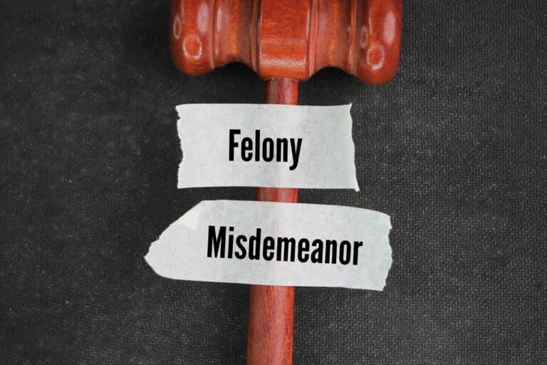 judge's gavel taped across with stickers showing words felony and misdemeanor