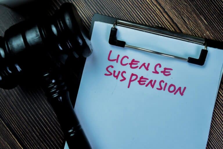 License Suspension written in red on paper with a gavel resting near on the table